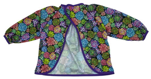 Long sleeved bib, waterproof, with built-in pocket bag In the SUCCULENTS